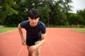 Young Asian Athletic man running in track to practice