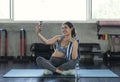 Young asian attractive smiling active fitness in gym and taking a selfie