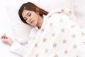 Young asian attractive woman sleeping in soft white pillow and bed on top view with white shirt pajamas and stars blanket. Royalty Free Stock Photo