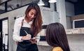 Young asian barista take order from customer in coffee shop,cafe owner writing drink order at counter bar,Food and drink business