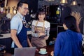 Young asian baristas ordering at counter bar in cafe. Cafe restaurant service, food and drink industry concept.