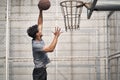 Young asian basketball player attempting a dunk Royalty Free Stock Photo