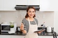 Young asian beautiful woman preparing food in kitchen at home Royalty Free Stock Photo