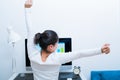 Young Asian beautiful woman sitting in front of computer and stretch oneself after long working. stree-free and relax Royalty Free Stock Photo