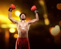 Young asian boxer man with boxing gloves celebrating a win Royalty Free Stock Photo