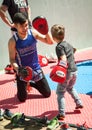Young Asian boxer training a small kid in Muay Thai