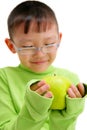 Young asian boy with a big green apple Royalty Free Stock Photo