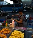 Bangkok, Thailand - October 20, 2019: Young Asian boy cooking fried food at a street market