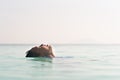 Young asian boy floating on a water relaxing in overflow swimming pool Royalty Free Stock Photo