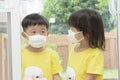 Young Asian boy and girl with face mask protection from coronavirus illnesses