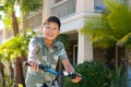 Young Asian boy on his bike in front of the house Royalty Free Stock Photo