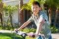 Young Asian boy on his bike in front of the house Royalty Free Stock Photo