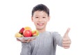 Young asian boy holding fruits and smiles Royalty Free Stock Photo