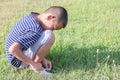 An young Asian boy is lacing white shoe rope. Royalty Free Stock Photo