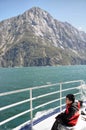 Asian boy looking at the mountains on a ferry trip in Milford Sound, NZ