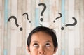 Young asian boy looking at question mark Royalty Free Stock Photo