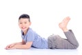 Young boy lying down on the floor over white