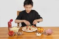Young Asian boy making home-made pizza Royalty Free Stock Photo