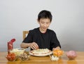 Young Asian boy making pizza Royalty Free Stock Photo