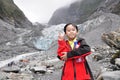 A young asian boy posing cheekily in front of franz joseph glacier, New Zealand Royalty Free Stock Photo