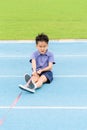 Young Asian boy pull a rope on blue track in the stadium