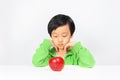 Young Asian boy reluctant to eat healthy food Royalty Free Stock Photo