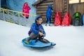 Young boy riding sleigh and smiles Royalty Free Stock Photo