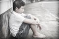 Young Asian boy sitting alone Royalty Free Stock Photo