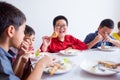 Boy smiling while having lunch with friends at school Royalty Free Stock Photo