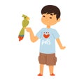 Young Asian boy smiling, holding a green parrot on his finger. Happy child with pet bird, casual clothes. Cute kid Royalty Free Stock Photo
