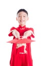 Boy smiling while holding red packet money isolated over white