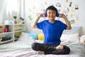 Young asian boy is smiling and listening to music Royalty Free Stock Photo