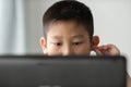 Young Asian boy using laptop technology at home.. Royalty Free Stock Photo