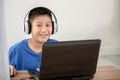 Young Asian boy using laptop technology at home. copyspace Royalty Free Stock Photo