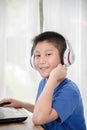 Young Asian boy using laptop technology at home. copyspace Royalty Free Stock Photo