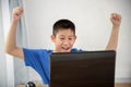 Young Asian boy using laptop technology at home.. Royalty Free Stock Photo