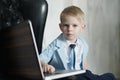 Young Asian boy using laptop technology at home. Royalty Free Stock Photo