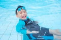 Young boy wearing goggles swimming in swimming pool Royalty Free Stock Photo