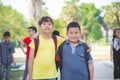 Boys friend standing in park and smiling at camera