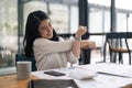 Young Asian Business Accountant woman stretching herself and relax while working hard Royalty Free Stock Photo