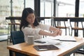 Young Asian Business Accountant woman stretching herself and relax while working hard. Royalty Free Stock Photo