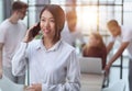 young asian business lady in white shirt talking on the phone Royalty Free Stock Photo