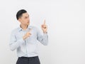 Young asian business man with blue shirt pointing to the side with a finger to present a product or an idea Royalty Free Stock Photo