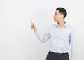 Young asian business man with blue shirt pointing to the side with a hand to present a product or an idea isolated on white Royalty Free Stock Photo