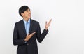 Young asian business man with blue shirt pointing to the side with a hand to present a product or an idea isolated on white Royalty Free Stock Photo