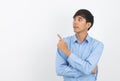 Young asian business man with blue shirt pointing to the side with a hand to present a product or an idea isolated on white Royalty Free Stock Photo