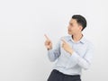 Young asian business man with blue shirt pointing to the side with a hand to present a product or an idea isolated on white Royalty Free Stock Photo