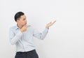 Young asian business man with blue shirt pointing to the side with a hand to present a product Royalty Free Stock Photo