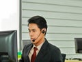 The young Asian business man is a customer service call center worker in business financial office Royalty Free Stock Photo