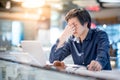 Young Asian business man feeling stressed while working with lap